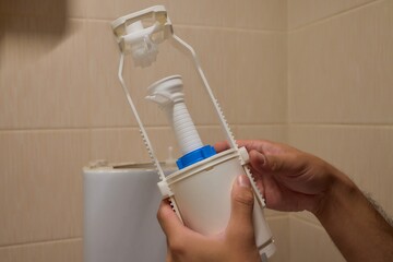 Hands skillfully Installing a Toilet Fill Valve in the Bathroom for Water Efficiency