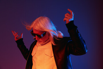 Stylish elderly man with long white hair wearing sunglasses, posing against a colorful purple and blue background, exuding a modern, confident vibe