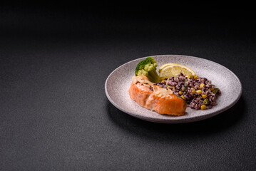 A piece of boiled salmon with rice, broccoli, salt and spices