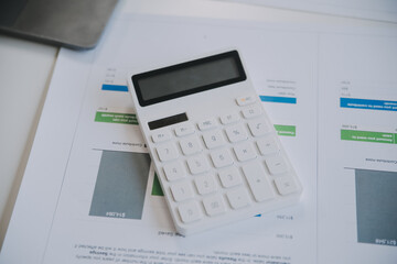 Financial analysts analyze business financial reports on a digital tablet planning investment project during a discussion at a meeting of corporate showing the results of their successful teamwork.