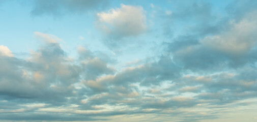 Beautiful tender sunrise sky with clouds. Sky background. 