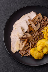 Asian dish with sliced chicken fillet, buckwheat noodles, soy sauce