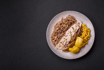 Asian dish with sliced chicken fillet, buckwheat noodles, soy sauce