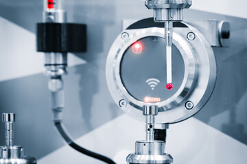 A machine is drilling a hole into a piece of metal. The machine is a CNC machine, which means it is computer controlled