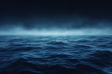 A dark blue ocean with a misty haze in the background