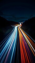 A long exposure photograph of the lights from cars on a highway at night