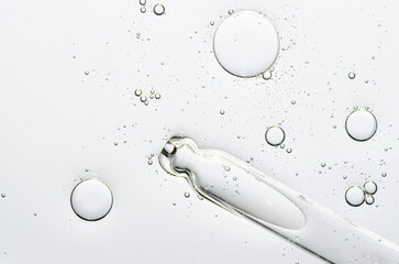 The texture of a cosmetic serum with a pipette closeup. Copy space