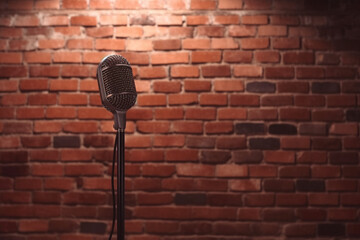 Stand up comedy stage microphone background brick wall.