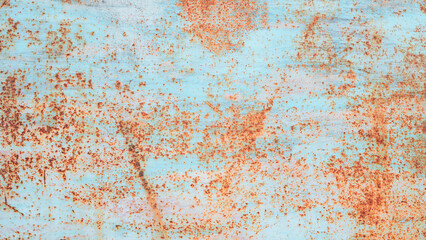 A rusty metal surface with blue and brown spots. The surface is rough and has a lot of texture background