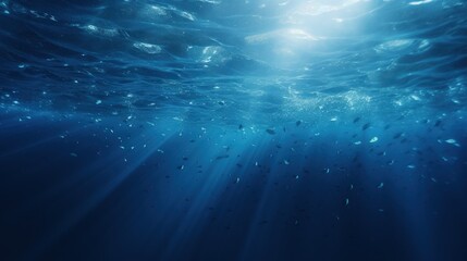 A serene underwater scene showcasing sunlight filtering through the ocean surface, illuminating the water and small fish.