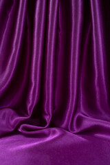Staged purple satin with folds and empty space for text or product placement