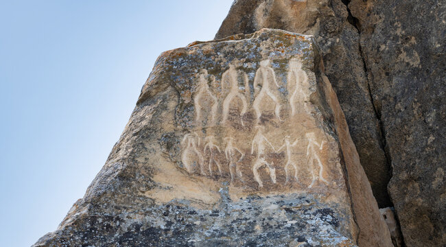 The dance of primeval people. Ancient rock carvings petroglyphs in Gobustan National park. Gobustan petroglyphs are listed by UNESCO as World Heritage. Gobustan near Baku, Azerbaijan.