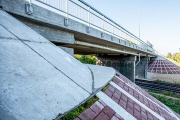 Road overpass with water drains over railway tracks, view from below