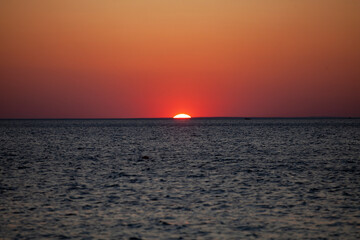 Sunset above the sea water 