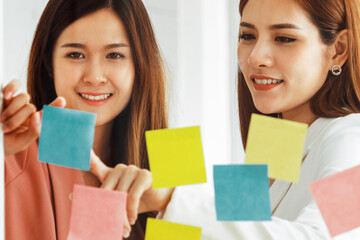 Creative Asian businesswoman in meeting workshop coming up with many positive ideas to help developing their corporate business. Group discussing and brainstorm concept. uds