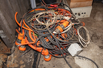 Photograph of old and dirty electrical power cables that have been left unattended and discarded on...