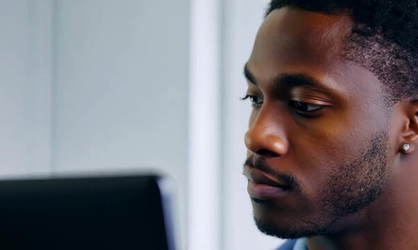 Gambian Man Creating a Budget Spreadsheet