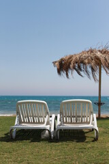 A pair of chairs on the sea beach of the hotel