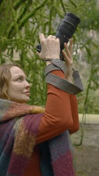 Female photographer shooting picturesque natural landscape in the National Park. Action. Side view of a caucasian woman enjoying adventurous trip to backcountry.