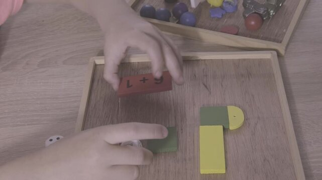 preschooler child builds colorful tower with wooden shapes, fostering creativity and problem-solving skills, early childhood learning, Back to school preparations