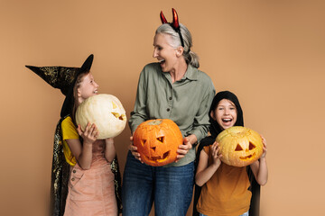 Happy family celebrating halloween holding carved pumpkins