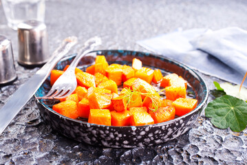Delicious homemade roasted sweet potato with herbs, salt and pepper