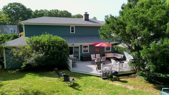 Drone moving closer to a backyard deck set up for a party. Labor Day Weekend 2024.