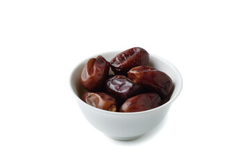 White bowl full of dry dates on white background.
