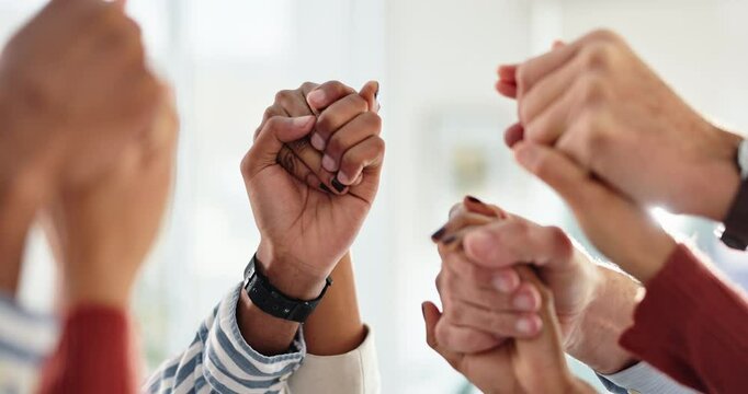 Business people, teamwork and holding hands with support in office for solidarity, trust and connection. Company, employees and gesture of unity in air for partnership, collaboration and motivation