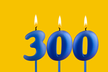 Blue candle number 300 - Birthday on yellow background