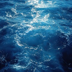 Deep Blue Ocean Water With White Foam and Sun Glare