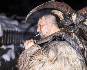 Man Wearing Traditional Goat Mask During Nighttime Carnival in the Alps