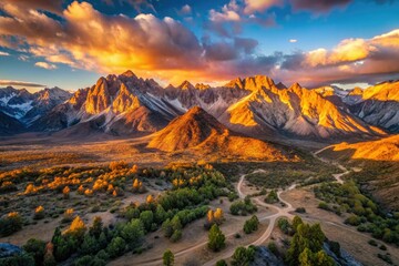 Naklejka premium dawn breaking rugged Sierra Nevada mountain range California USA cinematic drone aerial photography warm golden light dramatic shadows epic vast panoramic