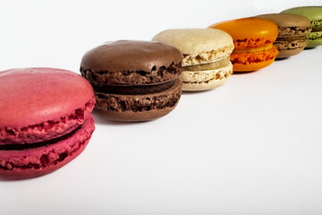 Sweet colorful macaroons isolated on a white background. Delicious colorful macarons. Sweets isolated on a white background. Photos of cookies for banners and websites.