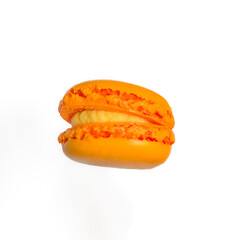 Sweet orange macarons with orange flavor isolated on white background. Delicious colorful macarons. Sweets isolated on a white background. Photos of cookies for banners and websites.