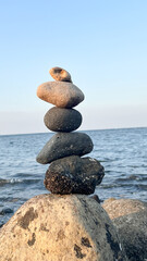 Balanced stones on the sea. arch from pebble on seacoast on summer day