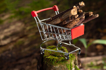 Firewood from the forest as fuel in a shopping cart. Selective focus.