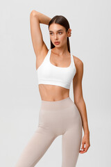 Fitness woman. Athletic girl on the gray background