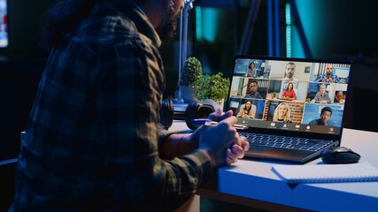 Employee working from home talking with coworkers during business meeting on videocall in office. Teleworker speaking in remote teleconference call from living room, camera A