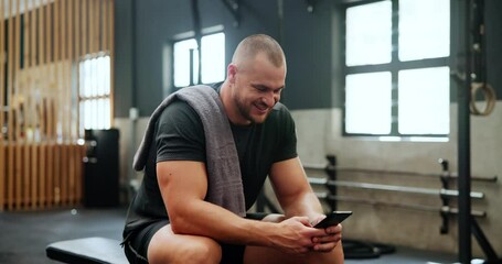 Athlete, man and phone in gym for break with happiness, relax and chat before exercise, workout or training. Bodybuilder, person and smartphone for internet, text message and fitness progress on app