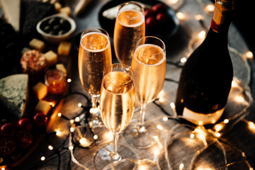 Glasses of sparkling wine or champagne served on the table for Christmas or New Year eve celebration.