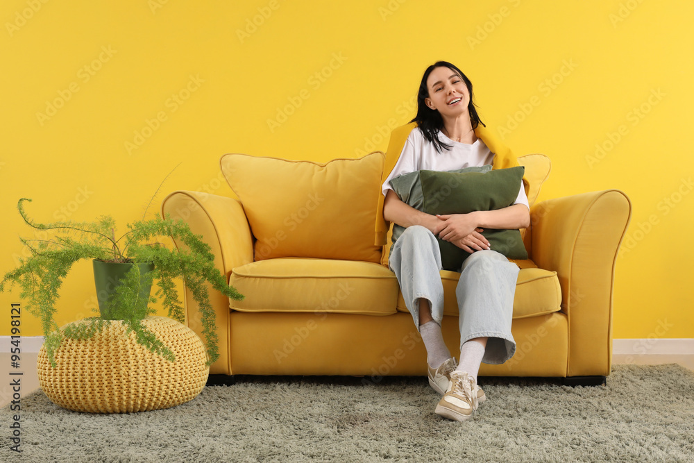 Canvas Prints beautiful young woman with pillow resting on yellow couch at home