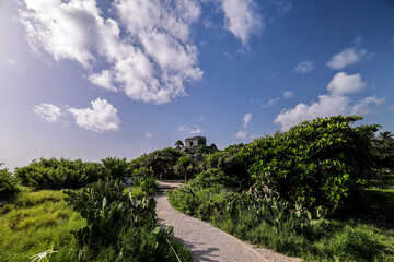 Tulum Ruins and Palm Tree, Tulum beach, Mayan ruins of Tulum at tropical coast. God of Winds Temple at paradise beach. Mayan ruins of Tulum, Quintana Roo, Mexico.