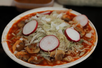 Delicious dinner of a tasty vegan style red mushroom pozole, hot and tasty, Mexican snacks.