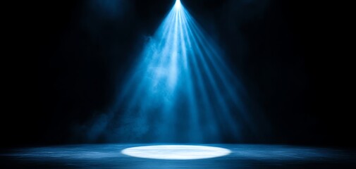 A dramatic spotlight shines down on an empty stage, creating an atmosphere of anticipation and creativity in a dark setting.