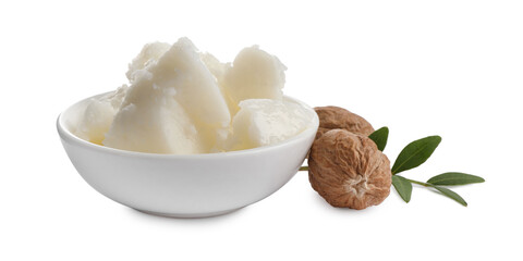 Natural shea butter in bowl, nuts and green twig isolated on white