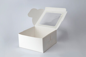 Empty white paper box with transparent window isolated on white background