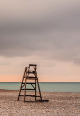 beach guardian chair on an empty beach at dawn