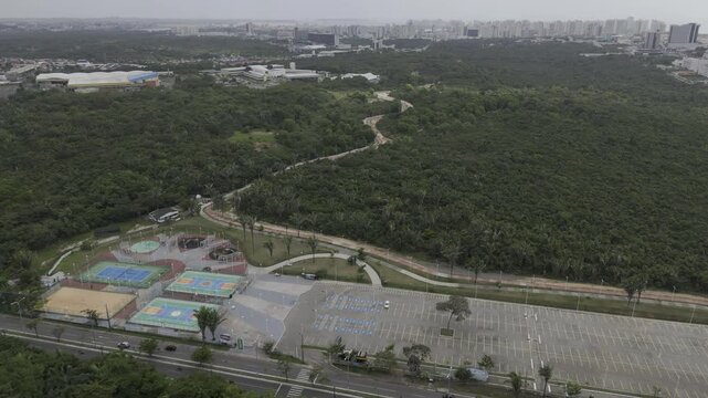 Drone flies to the left over Parque Estadual do Sitio do Rangedor on Sunday afternoon with empty parking lot in Sao Luis, Maranh&atilde;o, Brazil