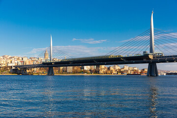 Golden Horn Halic Metro Bridge in Istanbul, Turkey against blue sky